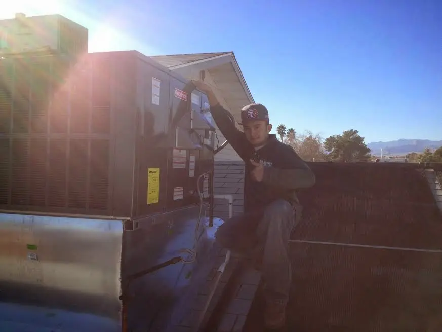 HVAC technician performing HVAC Inspection on a rooftop unit in Wilkinsburg